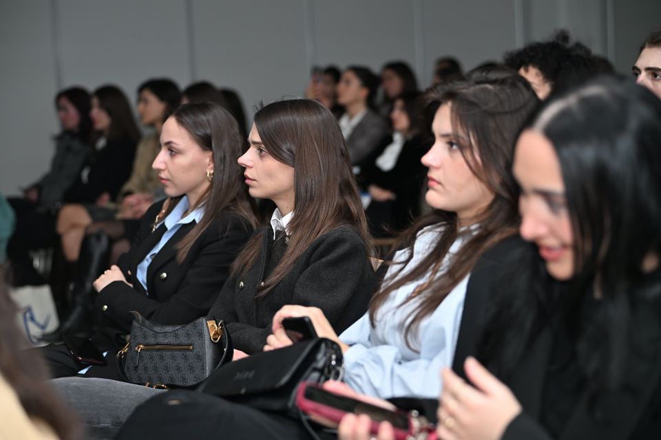 Attendees following a lecture closely