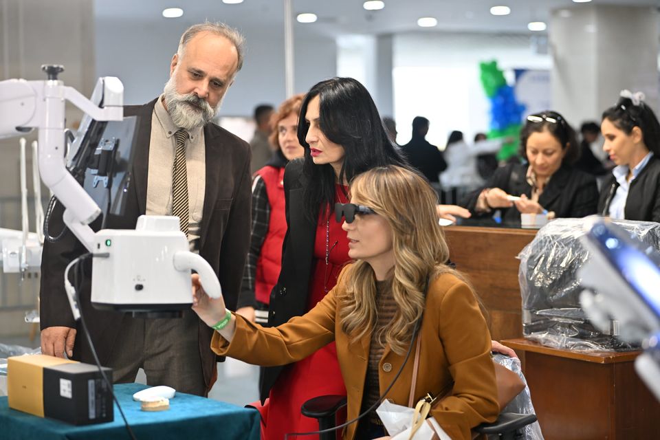 Exhibitors demonstrating equipment to visitors