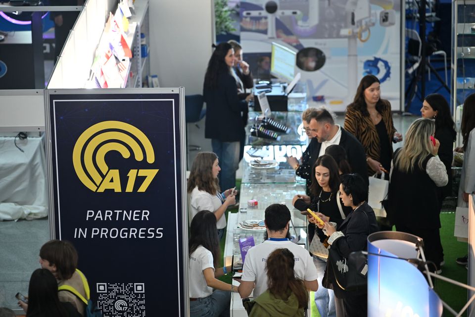 Visitors gathered around a stand at the exhibition