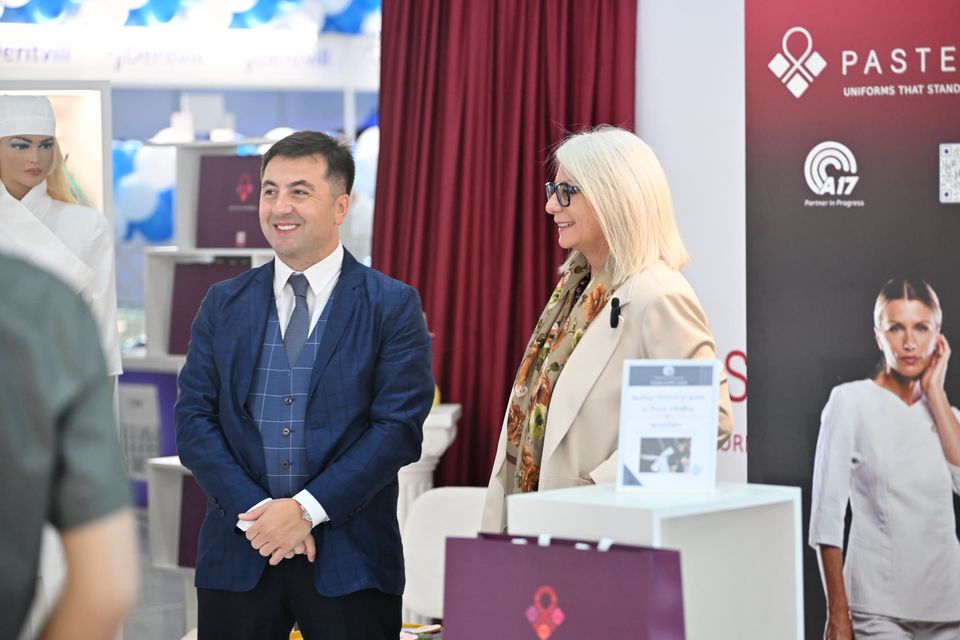 Two exhibitors welcoming guests at their stand