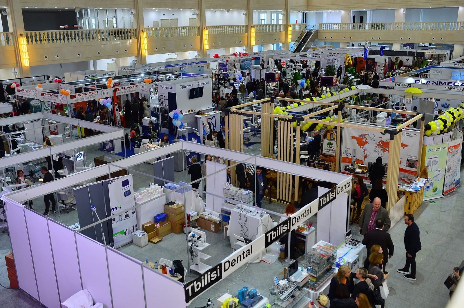 The exhibition hall at GDDA EXPO 2025, full of dental equipment stands and visitors