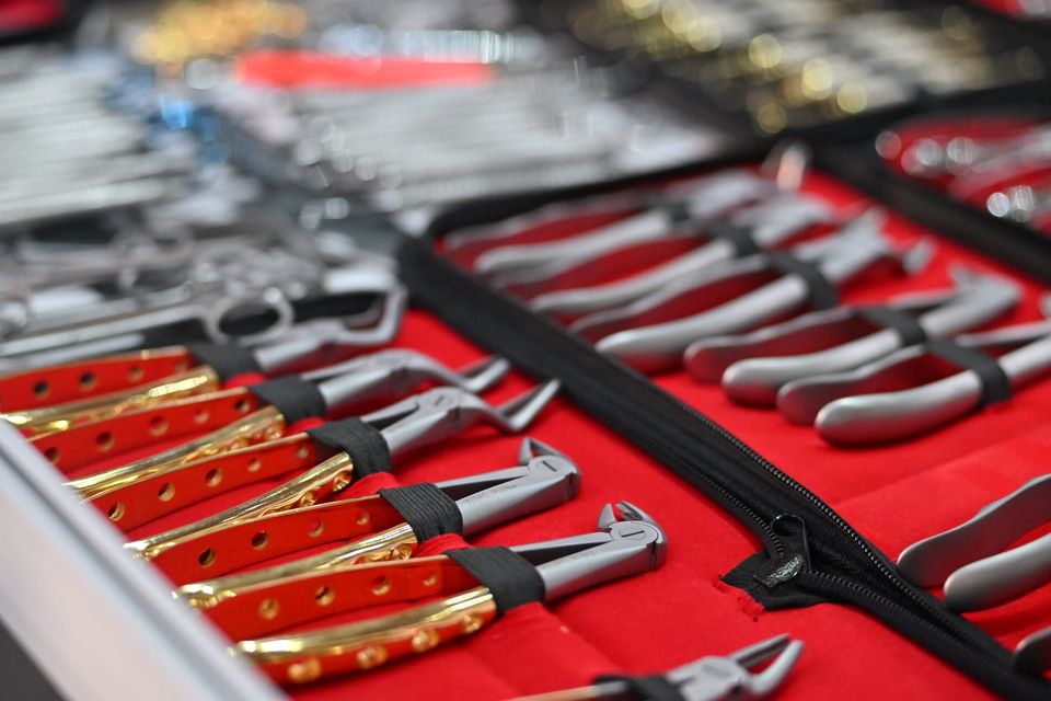 Extraction forceps laid out on red velvet