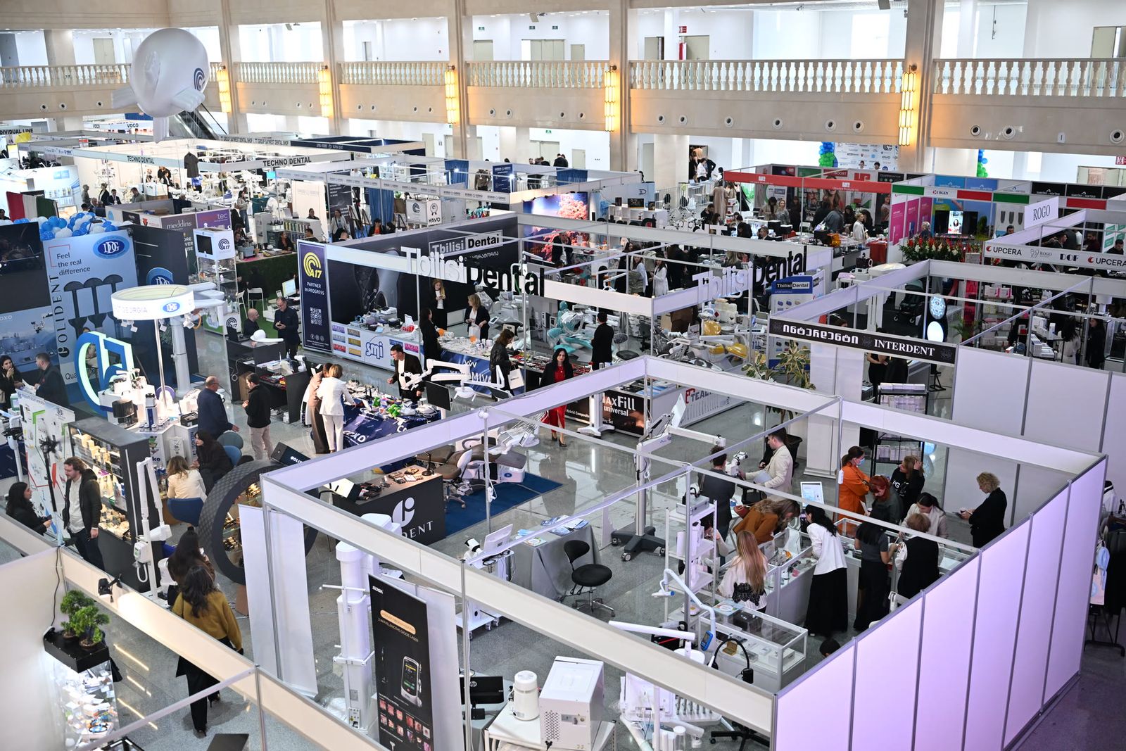 The exhibition hall from above, full of stands and visitors