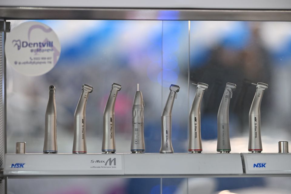 Dental handpieces lined up in a display case
