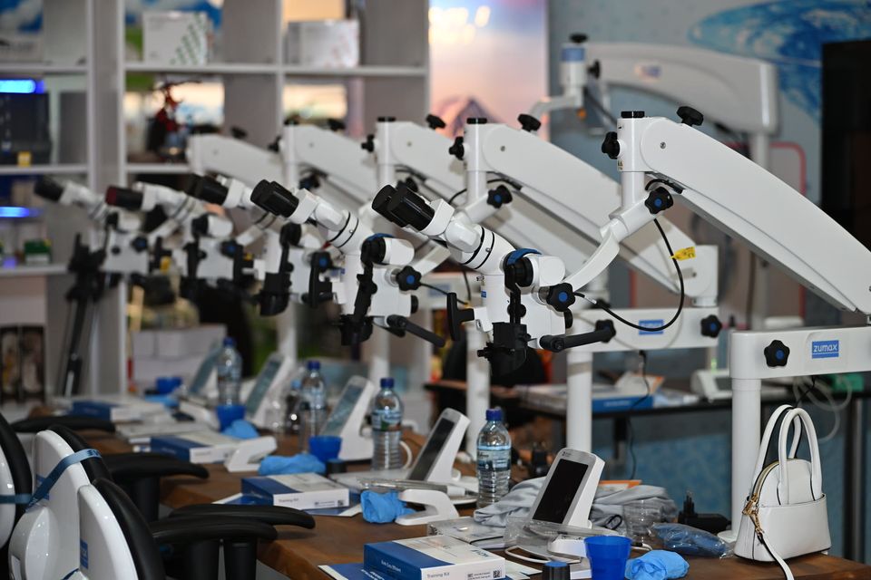 Dental microscopes lined up on an exhibitor’s stand